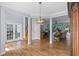Open living space features wood flooring, modern lighting, and seamless transitions to other rooms at 3430 Turningwind Ln, Winter Garden, FL 34787