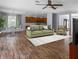 Staged living room with wood floors, a comfortable sofa, and an adjacent dining area and kitchen at 3430 Turningwind Ln, Winter Garden, FL 34787