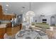 Open-concept living space with wood floors, stainless steel appliances, and decorative lighting at 3430 Turningwind Ln, Winter Garden, FL 34787