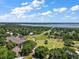 Breathtaking aerial view of the community's golf course and clubhouse near the beautiful lake at 39100 Tacoma Dr, Lady Lake, FL 32159
