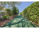 Lush backyard featuring manicured hedges and a walking path lined with greenery at 39100 Tacoma Dr, Lady Lake, FL 32159