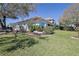 Landscaped backyard with mature plantings and well-maintained lawn at 39100 Tacoma Dr, Lady Lake, FL 32159
