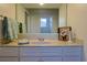 Well-lit bathroom featuring a marble countertop and a large mirror that adds depth at 39100 Tacoma Dr, Lady Lake, FL 32159