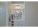 Bathroom with white vanity, large mirror, modern lighting, and a glass enclosed shower at 39100 Tacoma Dr, Lady Lake, FL 32159