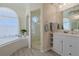 Bright bathroom featuring a glass shower, soaking tub, and vanity with modern fixtures at 39100 Tacoma Dr, Lady Lake, FL 32159