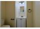Compact half-bath featuring white fixtures and a recessed mirror above the vanity at 39100 Tacoma Dr, Lady Lake, FL 32159