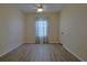 Bedroom with wood floors, natural light, and ceiling fan at 39100 Tacoma Dr, Lady Lake, FL 32159