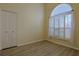 Bright bedroom with large window, plantation shutters and light-colored wood-look flooring at 39100 Tacoma Dr, Lady Lake, FL 32159