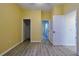 Bedroom with wood-look vinyl flooring, neutral paint, and views to other rooms at 39100 Tacoma Dr, Lady Lake, FL 32159