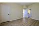 Bedroom with wood floors and view to ensuite bathroom at 39100 Tacoma Dr, Lady Lake, FL 32159