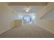 Large bonus room with neutral carpet, ceiling fan, and natural light at 39100 Tacoma Dr, Lady Lake, FL 32159