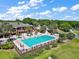 Aerial view of community pool, sundeck, and clubhouse at 39100 Tacoma Dr, Lady Lake, FL 32159