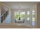 Dining area with chandelier, large window, and adjacent to a staircase at 39100 Tacoma Dr, Lady Lake, FL 32159