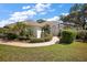 A beautiful single-story home featuring lush landscaping and a welcoming entrance at 39100 Tacoma Dr, Lady Lake, FL 32159