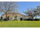 Charming single-story home with mature trees and lush green lawn at 39100 Tacoma Dr, Lady Lake, FL 32159
