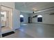 Spacious garage with white walls, arched windows, and an access door to the house at 39100 Tacoma Dr, Lady Lake, FL 32159
