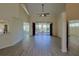 Open-concept living area with modern flooring, high ceilings, and access to an outdoor patio at 39100 Tacoma Dr, Lady Lake, FL 32159