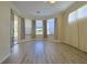 Spacious living room featuring gray-toned wood floors, neutral walls, and multiple windows at 39100 Tacoma Dr, Lady Lake, FL 32159