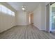 Open-concept living room with gray-toned wood flooring, neutral walls, and natural light at 39100 Tacoma Dr, Lady Lake, FL 32159