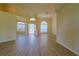 Sun-filled living room with contemporary flooring, neutral walls and a view of the home's entrance at 39100 Tacoma Dr, Lady Lake, FL 32159