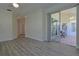 Light-filled living room with sliding doors to screened lanai, showcasing modern flooring and neutral decor at 39100 Tacoma Dr, Lady Lake, FL 32159