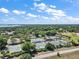 Aerial view of community tennis courts with lake view at 39100 Tacoma Dr, Lady Lake, FL 32159