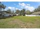 The backyard area is spacious with green grass, ready for landscaping and outdoor enjoyment at 40619 W 3Rd Ave, Umatilla, FL 32784