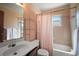 Standard bathroom featuring a single sink vanity, toilet, bathtub with shower curtain, and a mirror at 40619 W 3Rd Ave, Umatilla, FL 32784