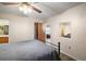 Bedroom featuring metal bed frame, ceiling fan, and closet with wooden door at 40619 W 3Rd Ave, Umatilla, FL 32784