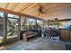 Covered outdoor space featuring wood ceiling, concrete floors, bench, and views of the backyard at 40619 W 3Rd Ave, Umatilla, FL 32784