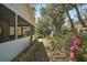 The property's side yard features a small path and lush landscaping at 40619 W 3Rd Ave, Umatilla, FL 32784