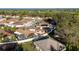 An aerial view showcases the neighborhood's layout, highlighting the homes with enclosed patios and manicured lawns at 427 Cambio Ct, The Villages, FL 32159