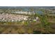 This aerial view shows the community's well-planned layout, proximity to lakes, and blend with the surrounding natural landscape at 427 Cambio Ct, The Villages, FL 32159