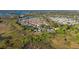 Scenic aerial view of a well-maintained neighborhood surrounded by lush greenery and waterways at 427 Cambio Ct, The Villages, FL 32159