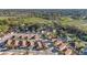 Peaceful aerial view of a quiet neighborhood street surrounded by mature trees at 427 Cambio Ct, The Villages, FL 32159