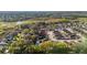 An aerial view shows the neighborhood’s proximity to natural wetlands, offering scenic views and wildlife observation opportunities at 427 Cambio Ct, Lady Lake, FL 32159