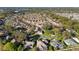 An aerial shot of a community with mature trees and well-maintained homes. Lush green spaces surround the neighborhood at 427 Cambio Ct, The Villages, FL 32159