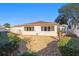 Backyard view of the house showing the patio and low-maintenance landscaping at 427 Cambio Ct, The Villages, FL 32159