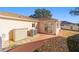 Exterior view of the house from the back with concrete patio, lawn, and storage at 427 Cambio Ct, The Villages, FL 32159