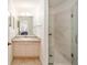 Bathroom featuring a granite countertop and a modern, glass-enclosed shower at 427 Cambio Ct, The Villages, FL 32159