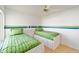 Bedroom featuring two twin beds, a ceiling fan, and a window with natural light at 427 Cambio Ct, The Villages, FL 32159
