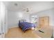 Relaxing bedroom featuring a cozy bed, hardwood floors, and ample closet space at 427 Cambio Ct, The Villages, FL 32159