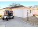 Charming single-story home featuring a golf cart, a pristine two-car garage and a well-kept stone landscaped yard at 427 Cambio Ct, The Villages, FL 32159