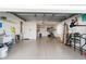Spacious two-car garage featuring epoxy flooring, sink, and storage at 427 Cambio Ct, The Villages, FL 32159