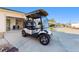 Golf cart in front of open garage of a home in a golf cart friendly community at 427 Cambio Ct, The Villages, FL 32159