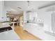 Open kitchen with white cabinetry, stainless steel appliances, breakfast bar, and seamless flow to other living spaces at 427 Cambio Ct, The Villages, FL 32159