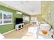 Spacious living room featuring a comfortable sofa, large windows, and views of the dining area at 427 Cambio Ct, The Villages, FL 32159