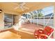 Enclosed patio featuring ceiling fan, sliding glass door, and cushioned patio furniture at 427 Cambio Ct, The Villages, FL 32159