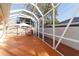 Screened-in patio with painted concrete floor and an outdoor chair at 427 Cambio Ct, The Villages, FL 32159