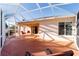 Enclosed back patio with ceiling fan, sliding glass door, and patio chairs at 427 Cambio Ct, The Villages, FL 32159